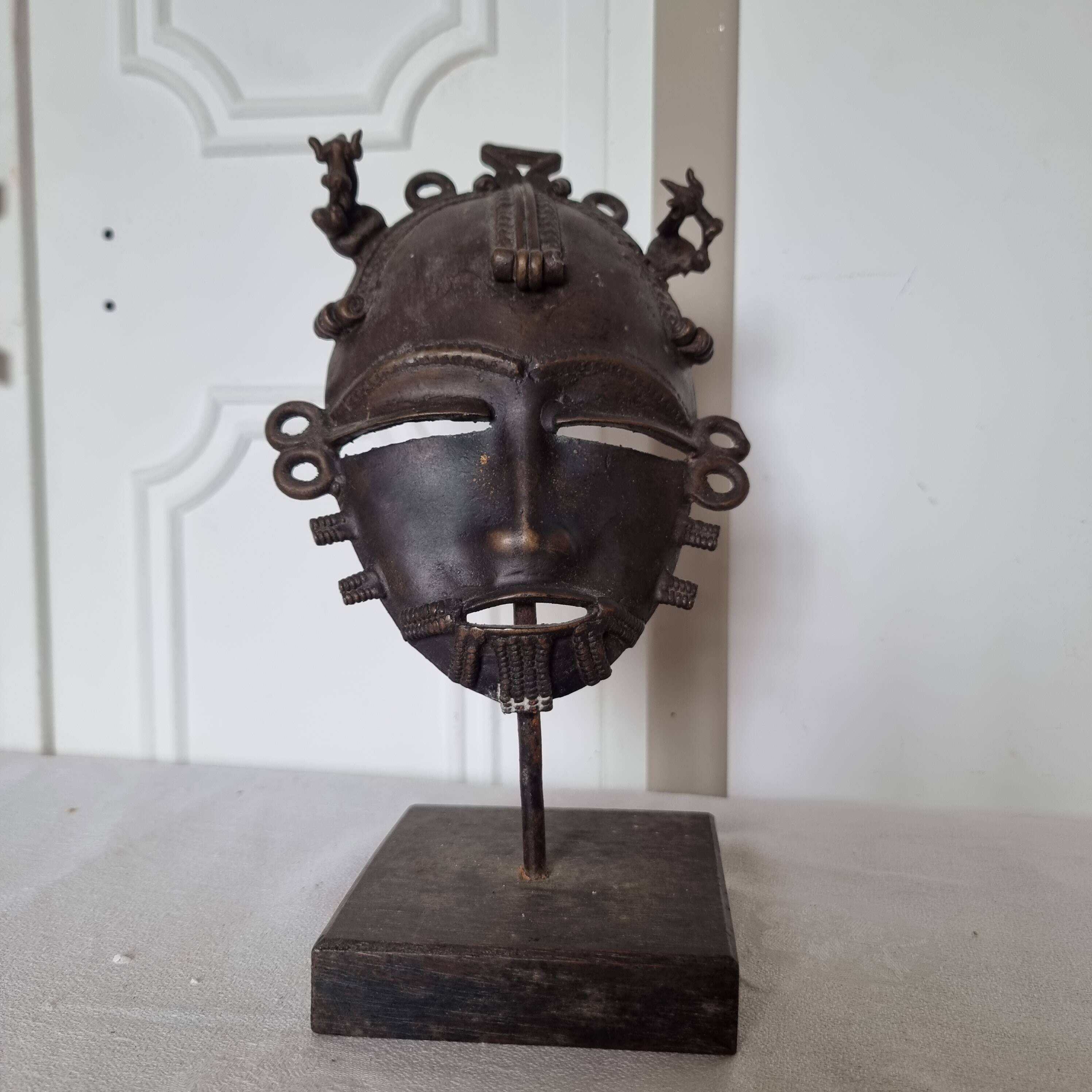 African bronze mask on pedestal, from Ivory Coast, dating