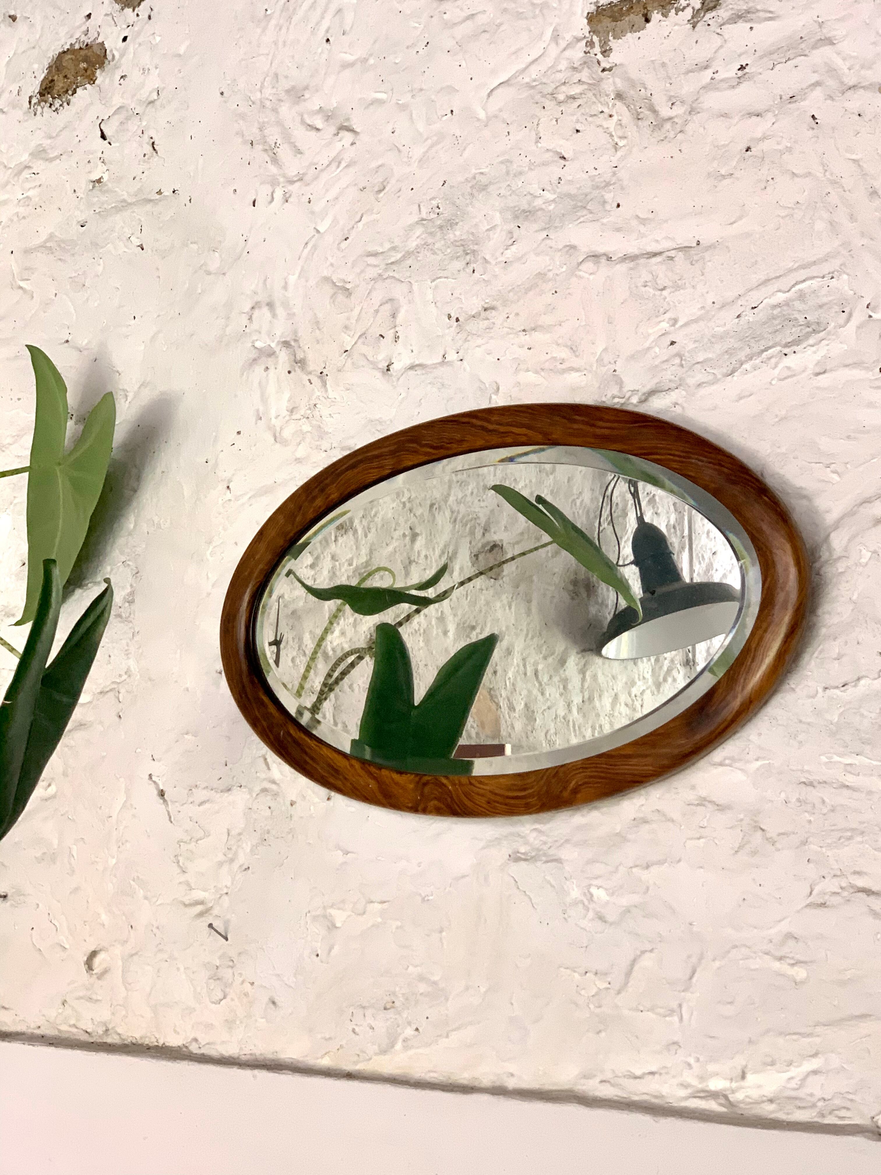 Oval wooden and stucco wall mirror
