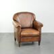 Comfortable characterful sheepskin armchair finished with decorative nails