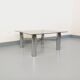 Square Italian vintage Space Age coffee table in smoked glass and metal.