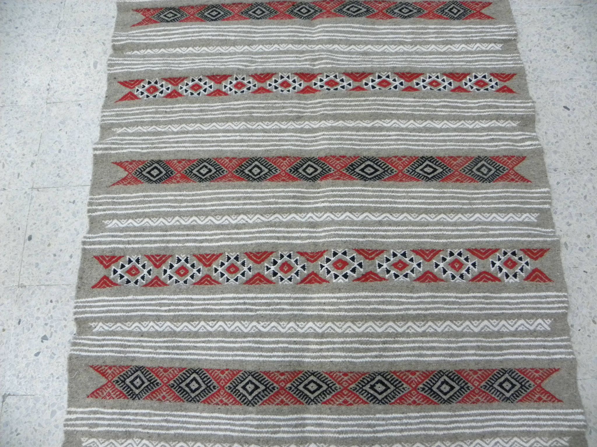 Geometric woven rug with fringes – Ethnic style – Hallway & interior
