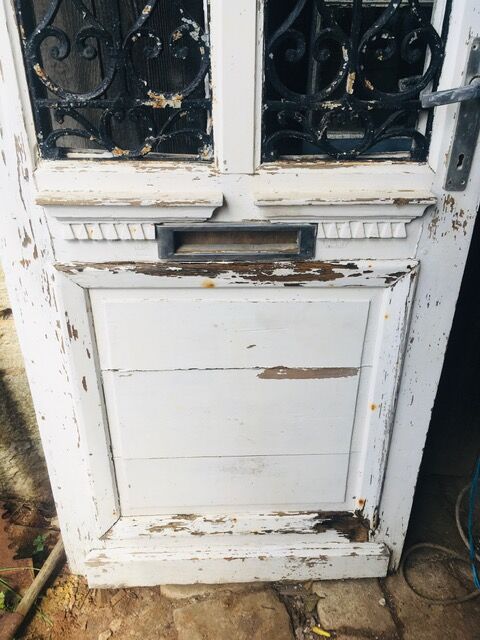 Old door with wrought iron grille