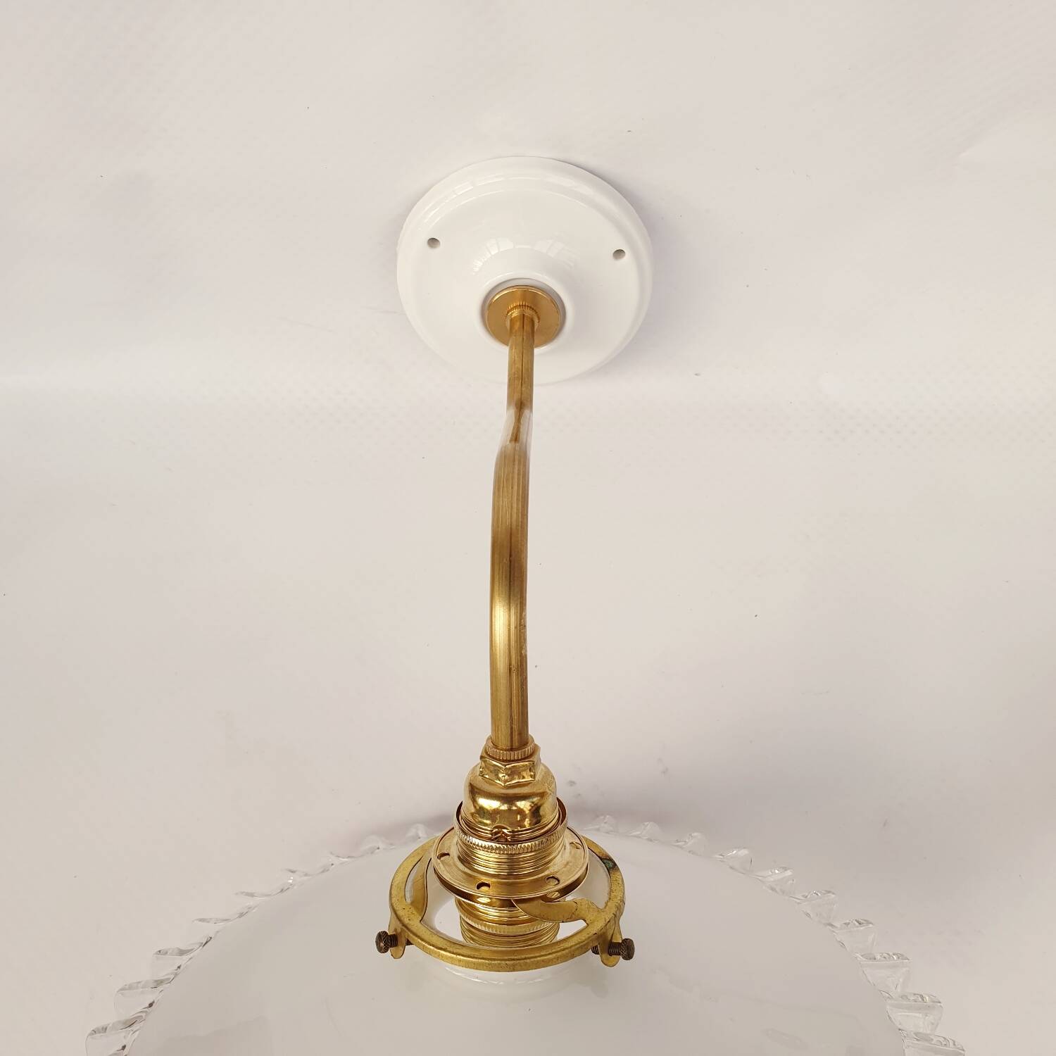 Swan neck sconces in serrated opaline