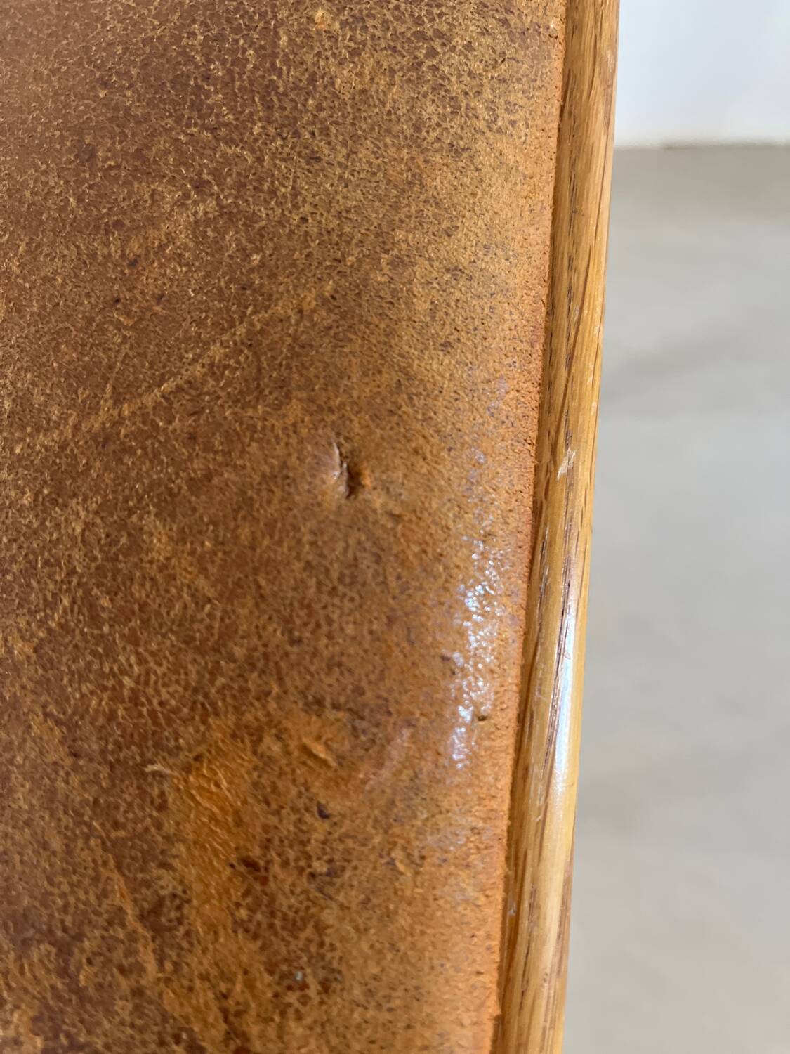 Vintage stool from the 60s with aged leather seat
