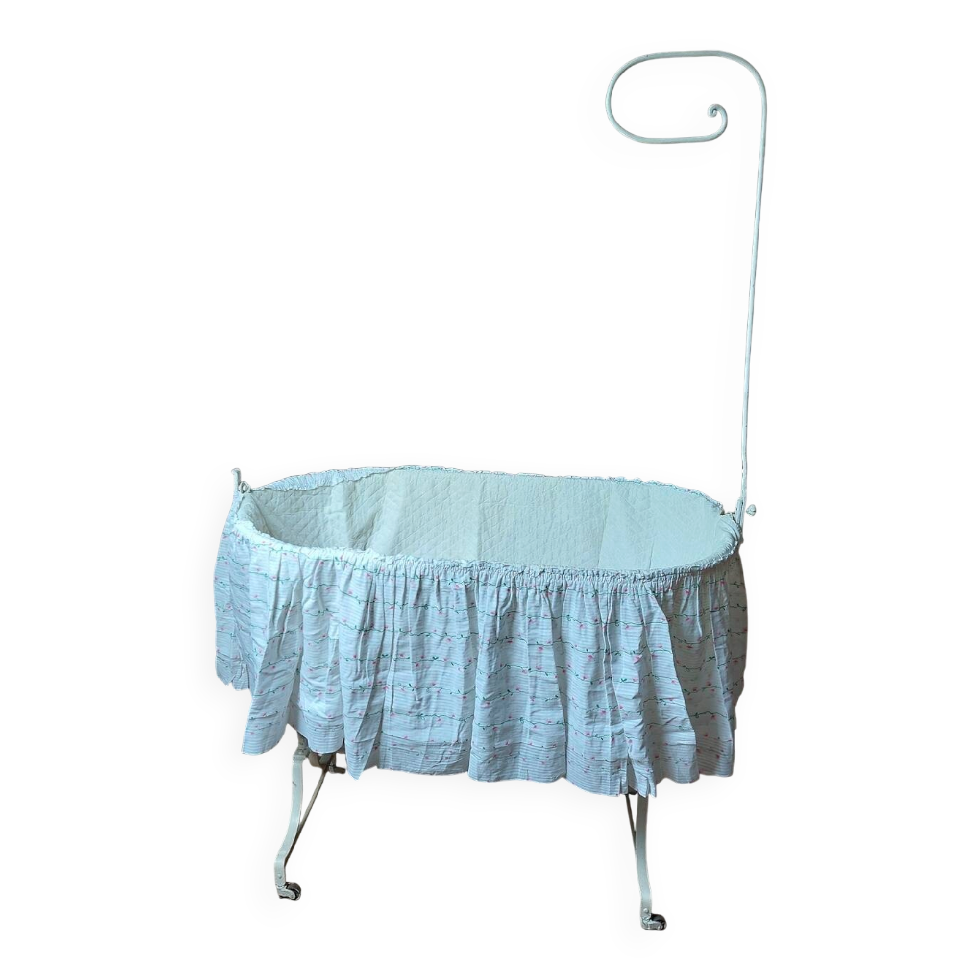 Wrought iron crib painted white from around 1920 with bedding.