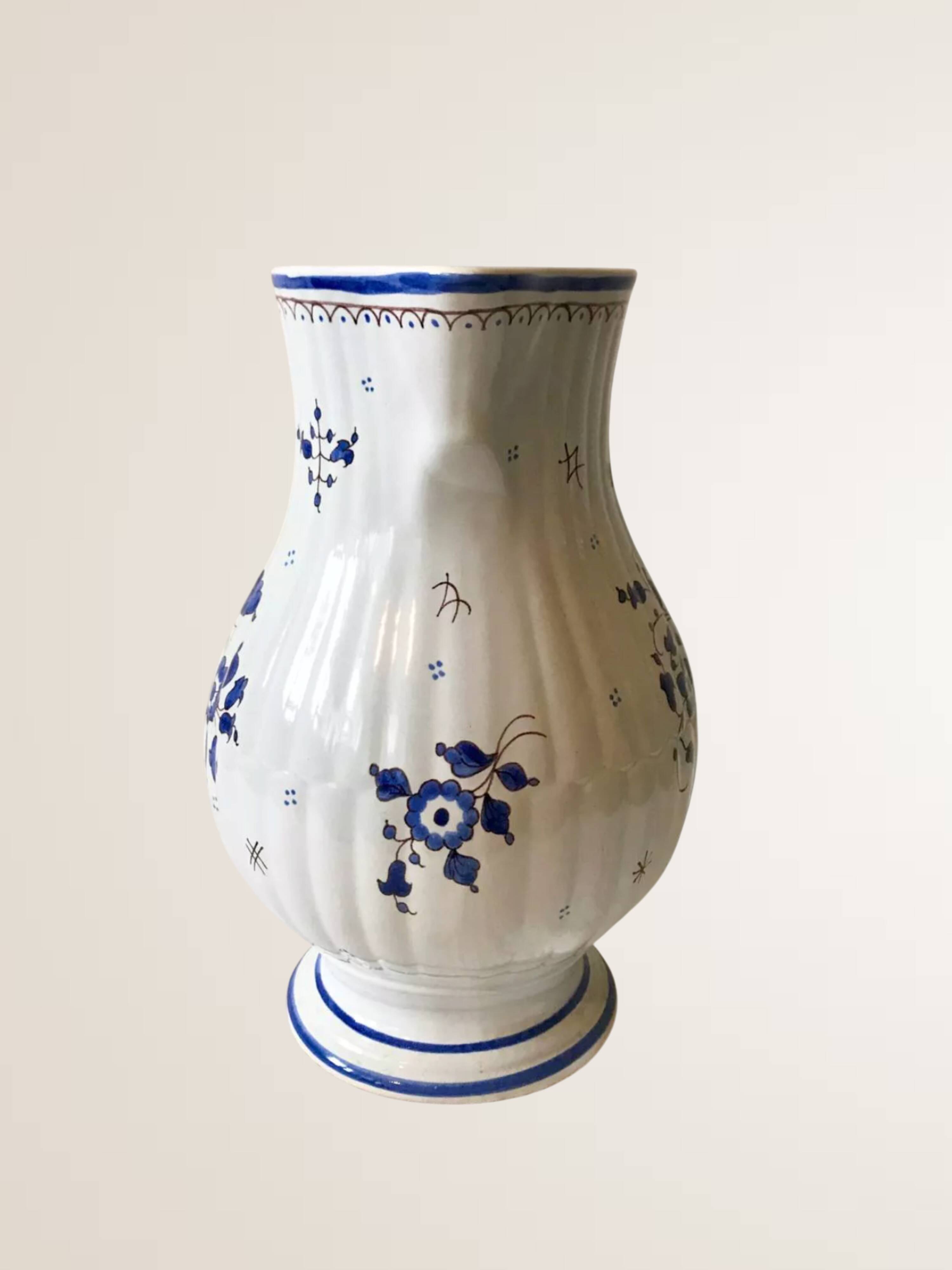 Moutiers earthenware jug, hand-painted blue decoration.