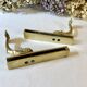 Brass wall supports for bathroom shelf, circa 1950.