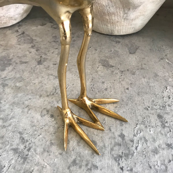 Crested bird in golden brass