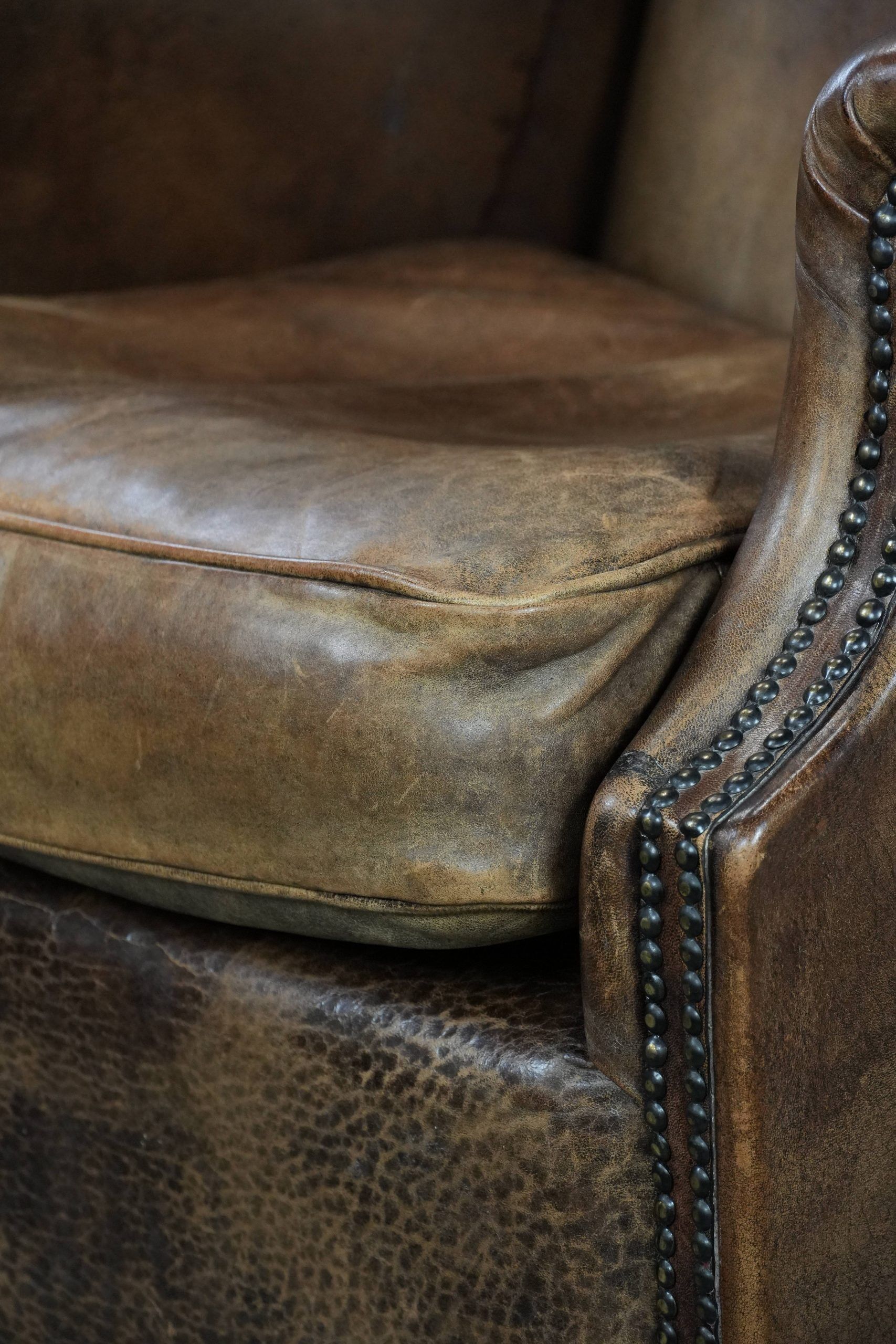 Warm, cosy and comfortable vintage sheepskin ear armchair with character