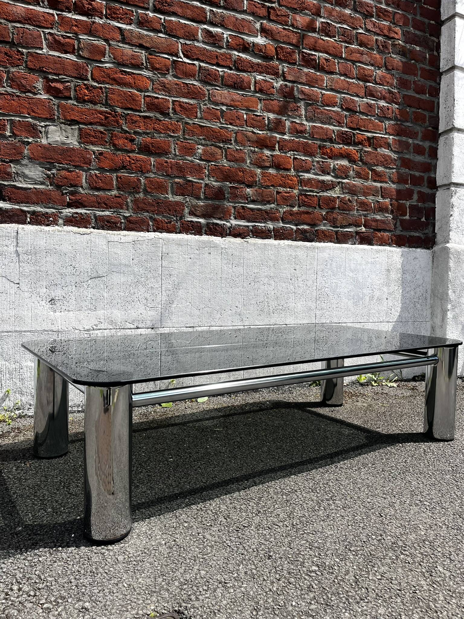 Vintage coffee table with smoked glass and chrome.