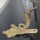 Vintage brass coat hook with marine creature motif and medallion.