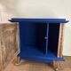 Small vintage upcycled side table in midnight blue and raw wood, with a rose-shaped door.