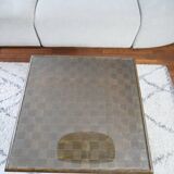 Square table in woven chestnut, with glass top
