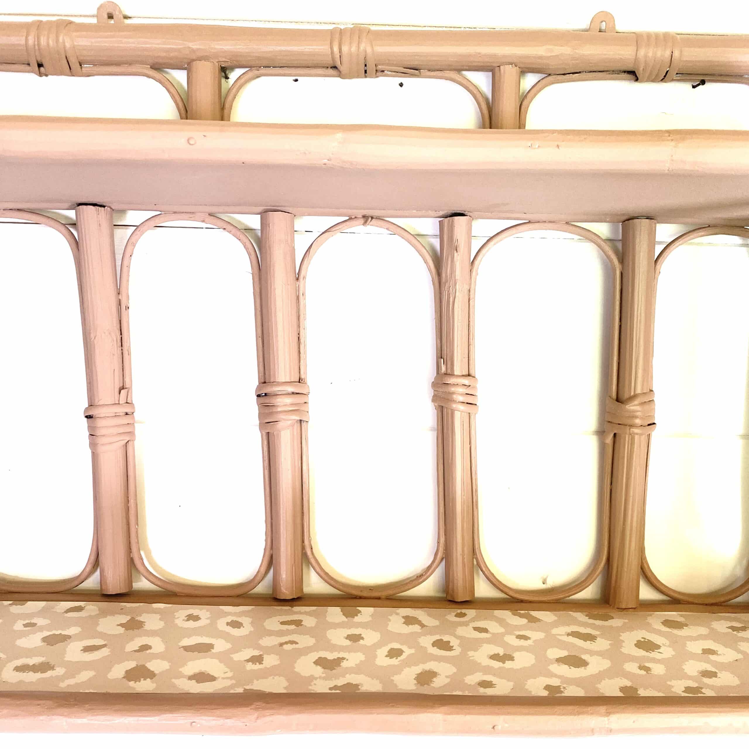 Pale pink rattan wall shelf