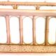 Pale pink rattan wall shelf