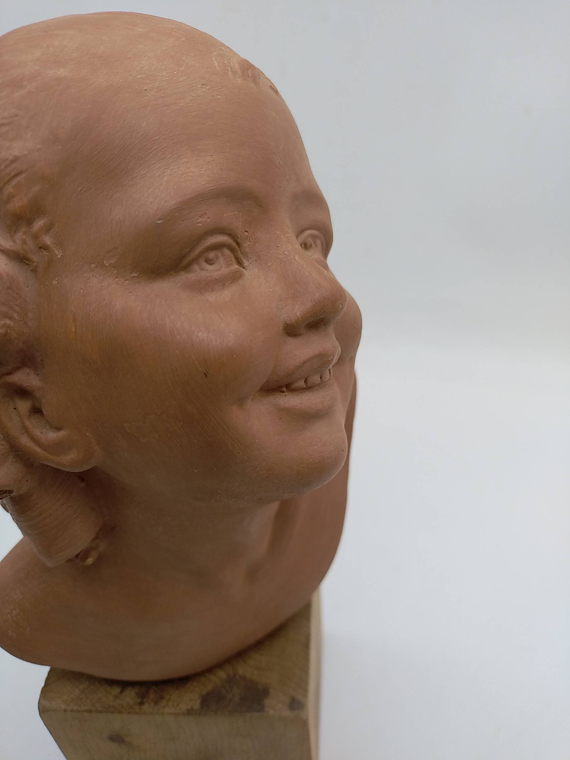 Bust young smiling girl. Circa 1900. Art Deco. Signed.