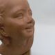 Bust young smiling girl. Circa 1900. Art Deco. Signed.