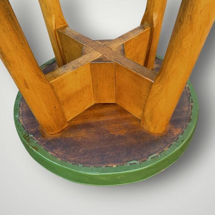 Old solid wood bar stool, metal footrest, green leatherette seat