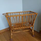 Rattan wicker cradle on wooden wheels