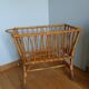 Rattan wicker cradle on wooden wheels