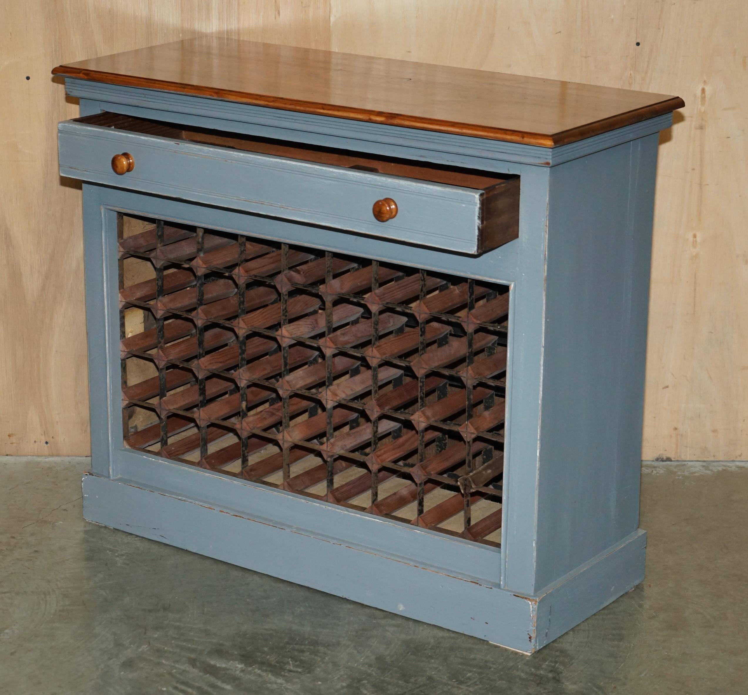 Vintage wooden furniture for 45 wine bottles with a drawer.