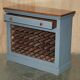 Vintage wooden furniture for 45 wine bottles with a drawer.