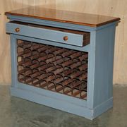 Vintage wooden furniture for 45 wine bottles with a drawer.
