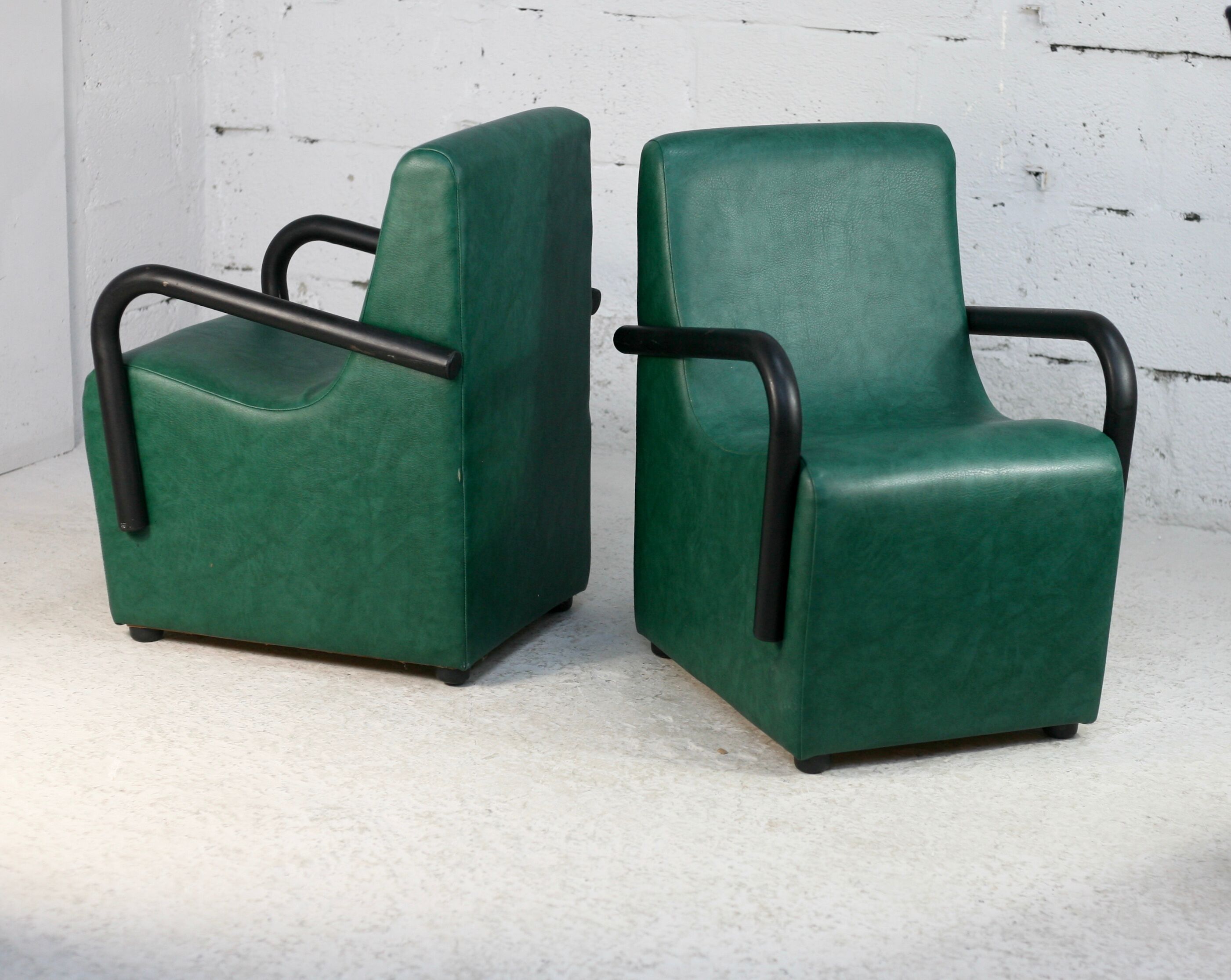 Pair of armrest heaters. Steel and green imitation leather. France, circa 1980