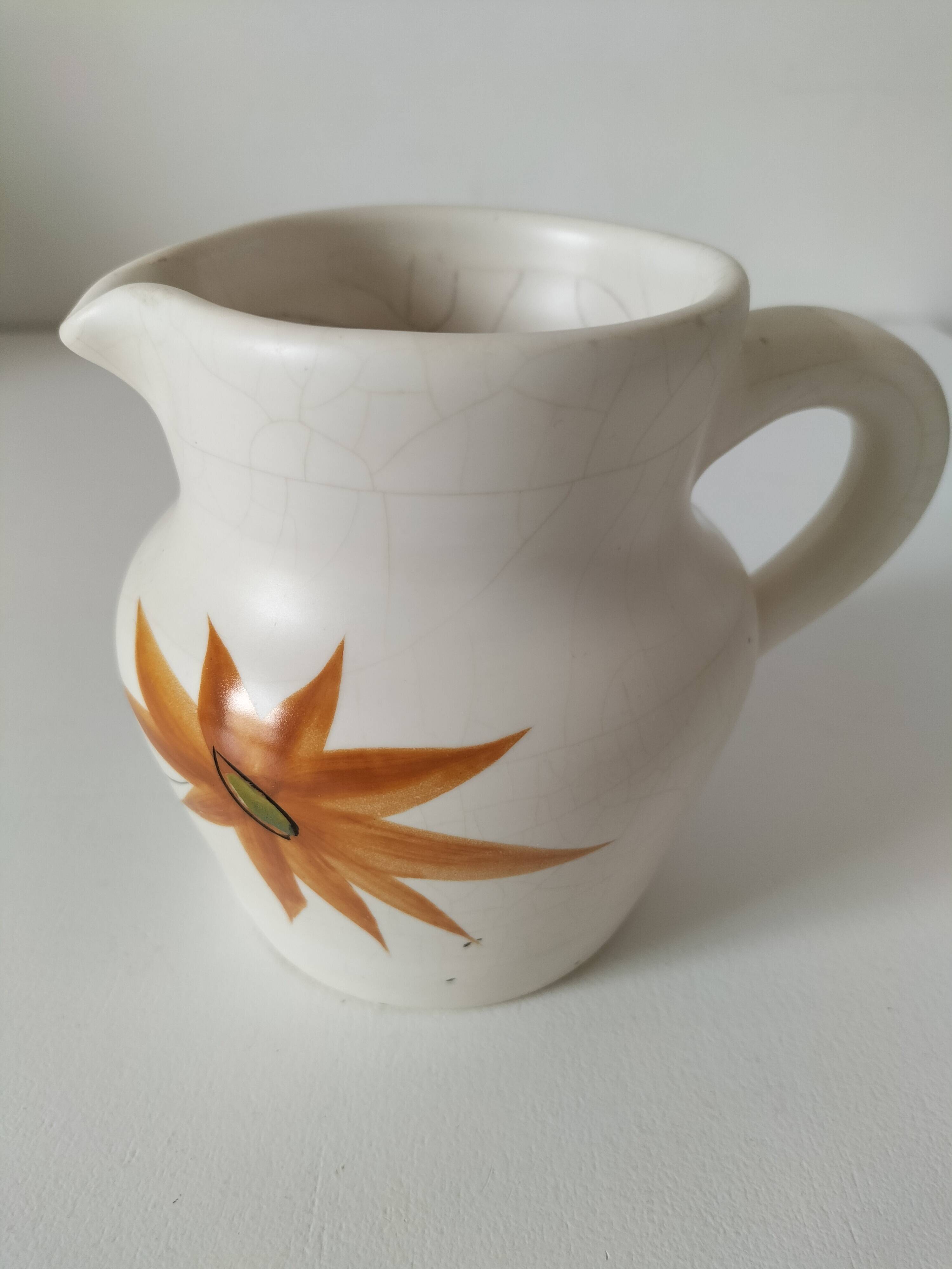 Vintage Marais pottery pitcher with orange floral decoration