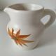 Vintage Marais pottery pitcher with orange floral decoration