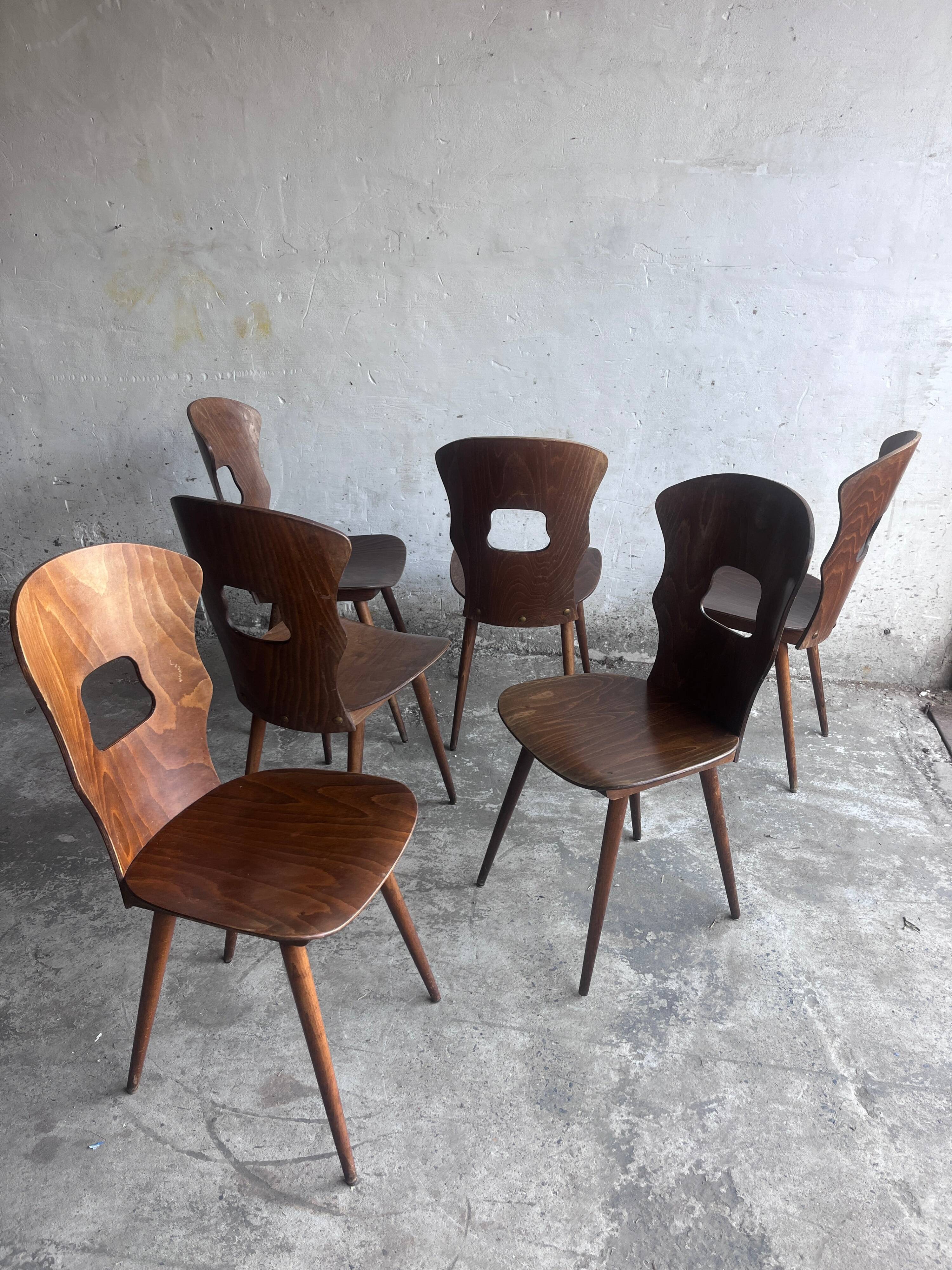 Set of six plywood dining chairs by Baumann, France, 1950s.