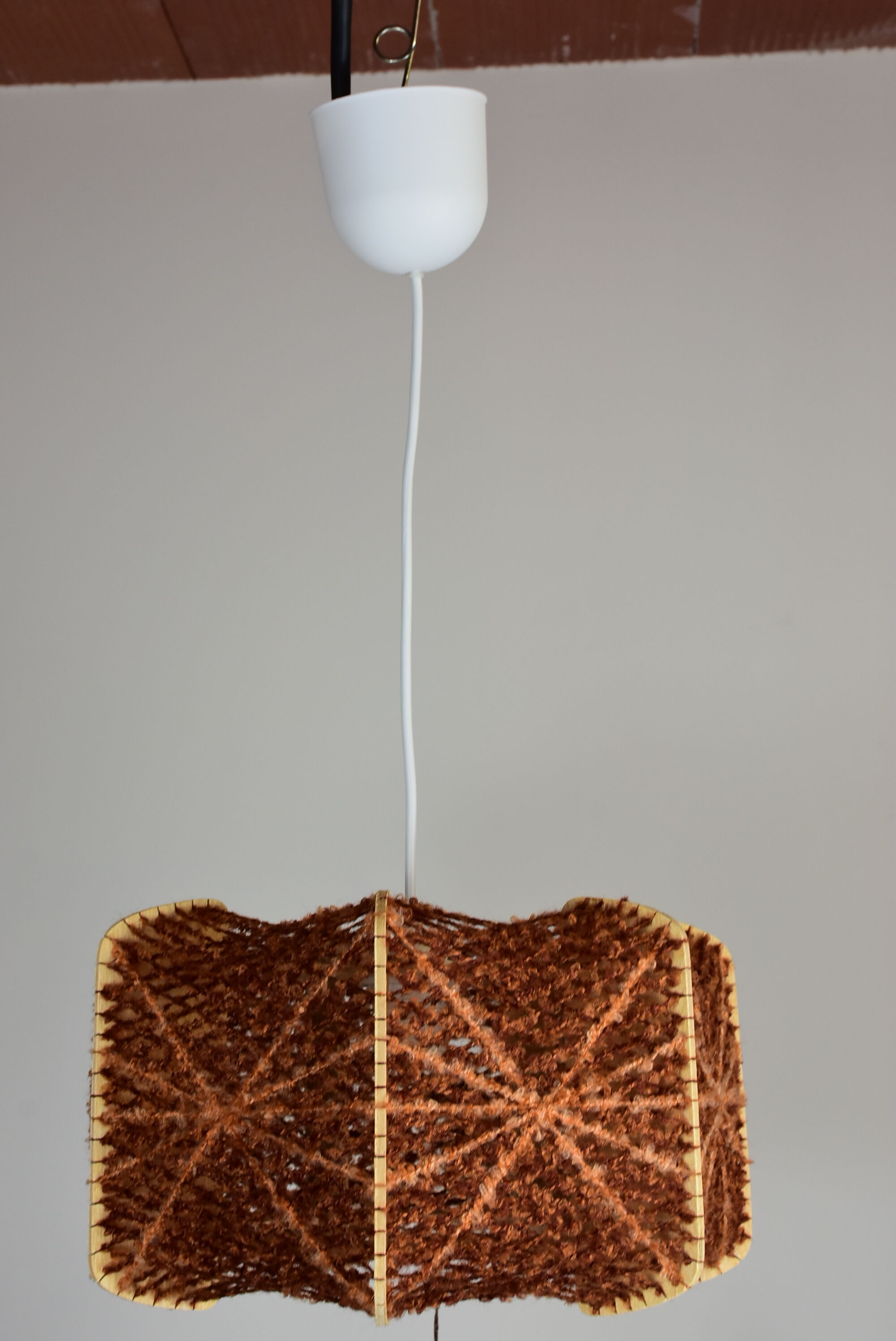 Brown wire and wood pendant light.