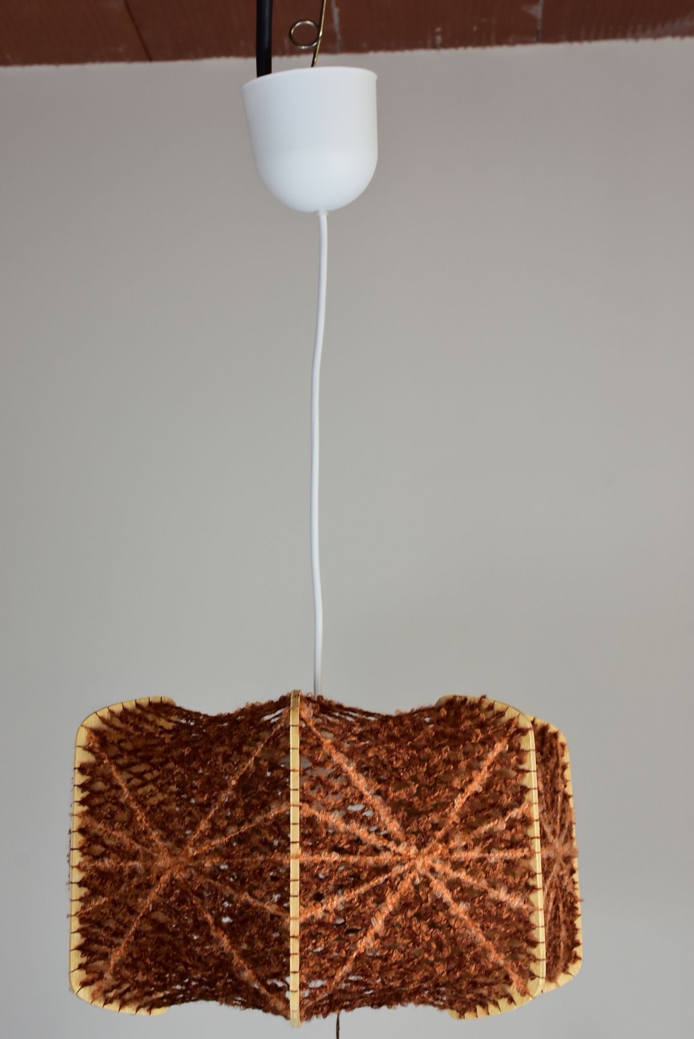Brown wire and wood pendant light.