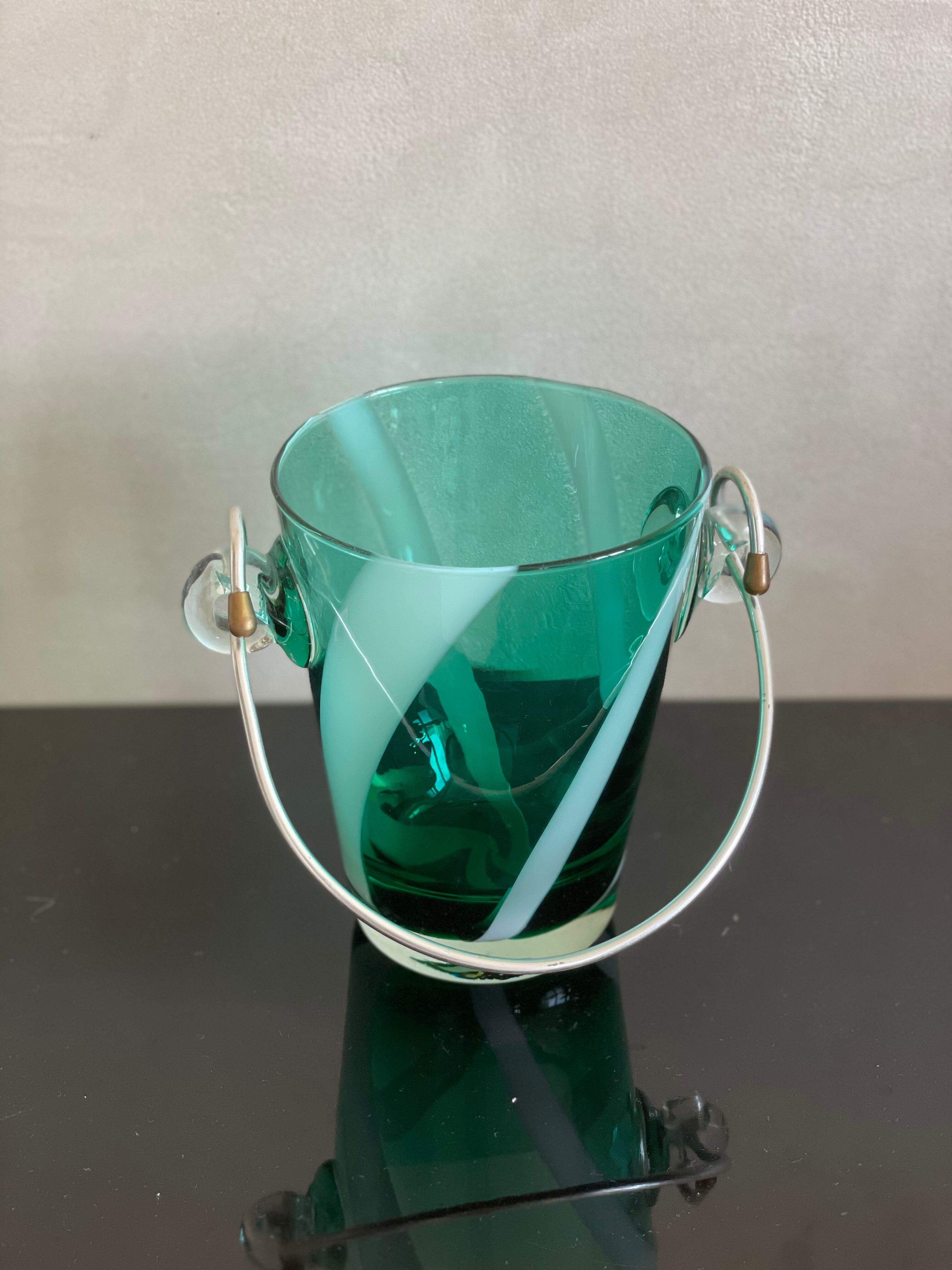 Bucket with ice cubes colored green glass
