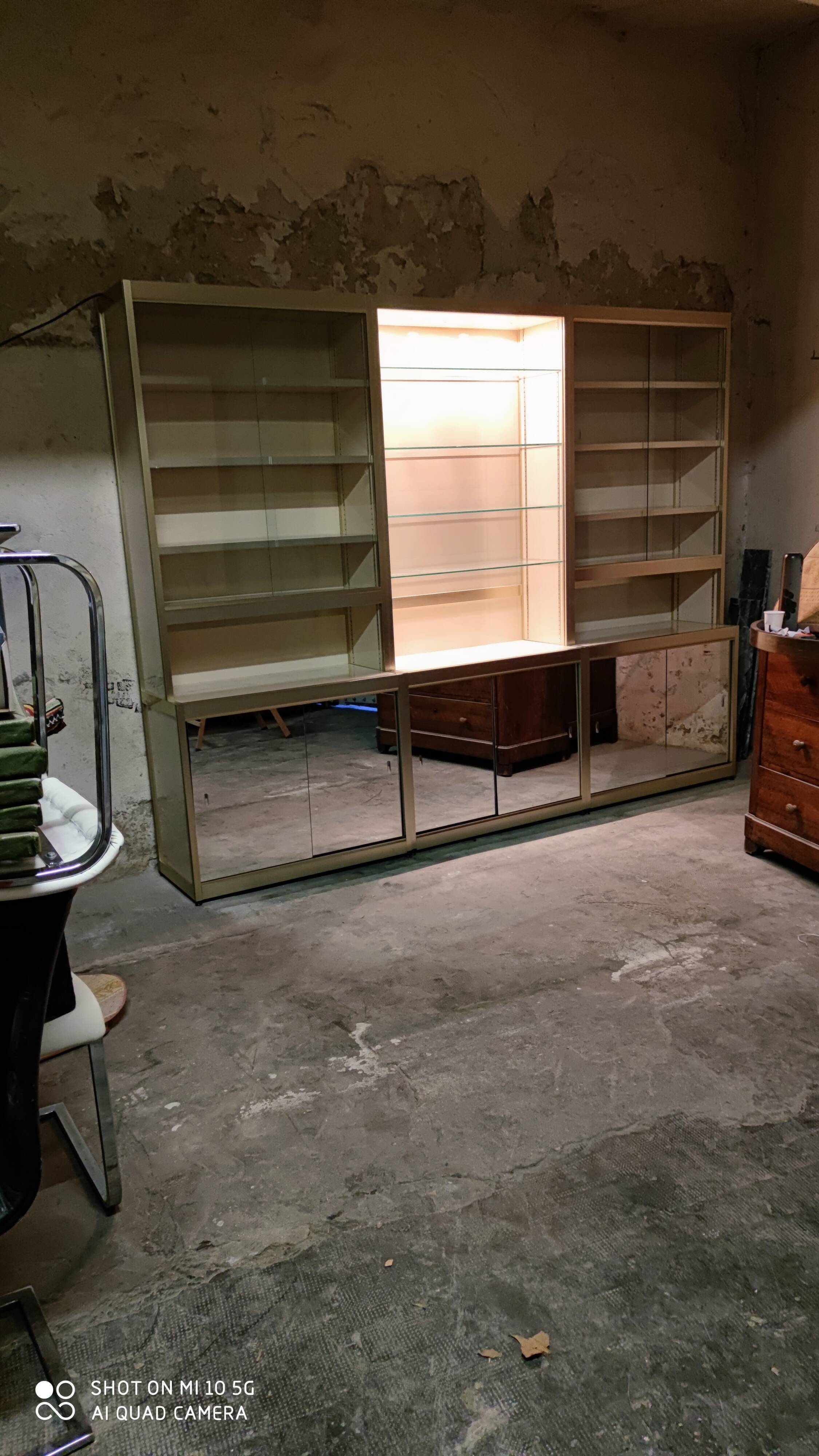 Ivory-colored and matte gold anodized aluminum display bookcase