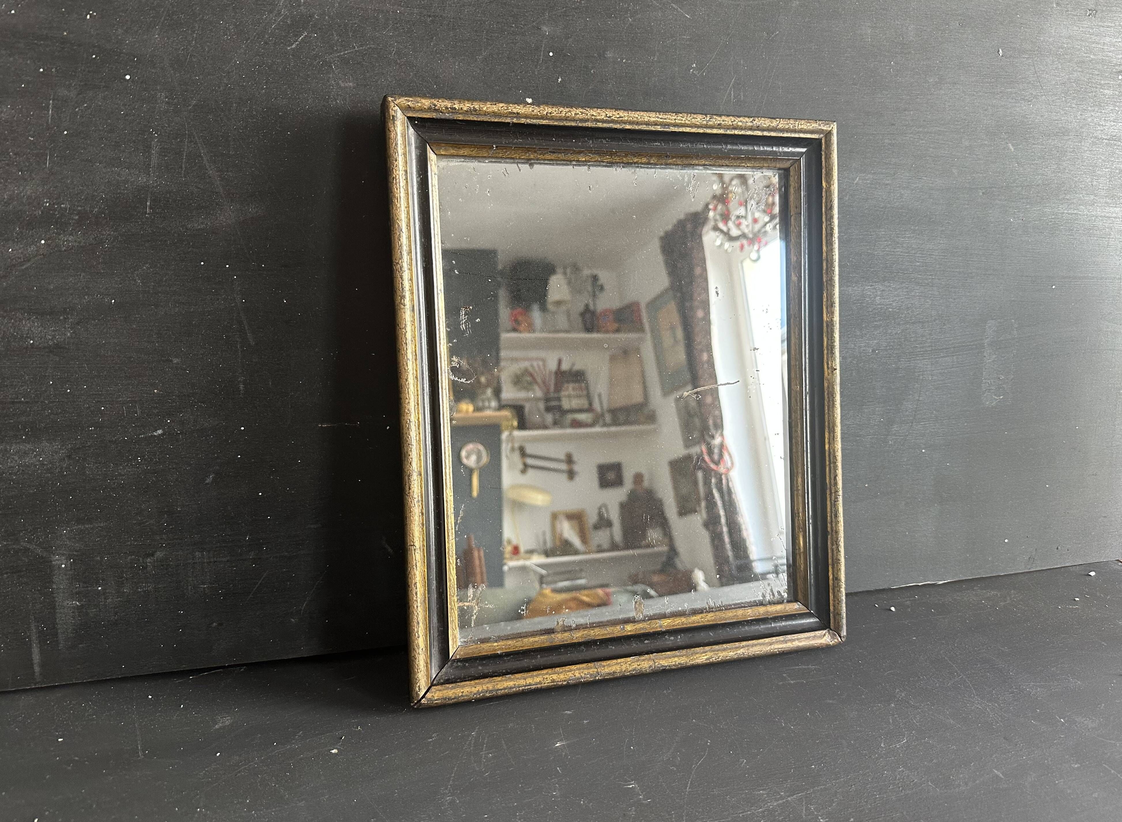 Miroir Napoléon III en bois noir et doré, XIXe siècle