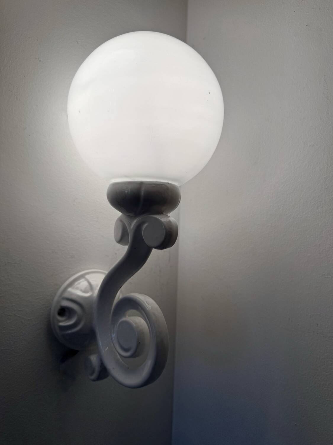 Cast iron and opaline wall lights from the 70s