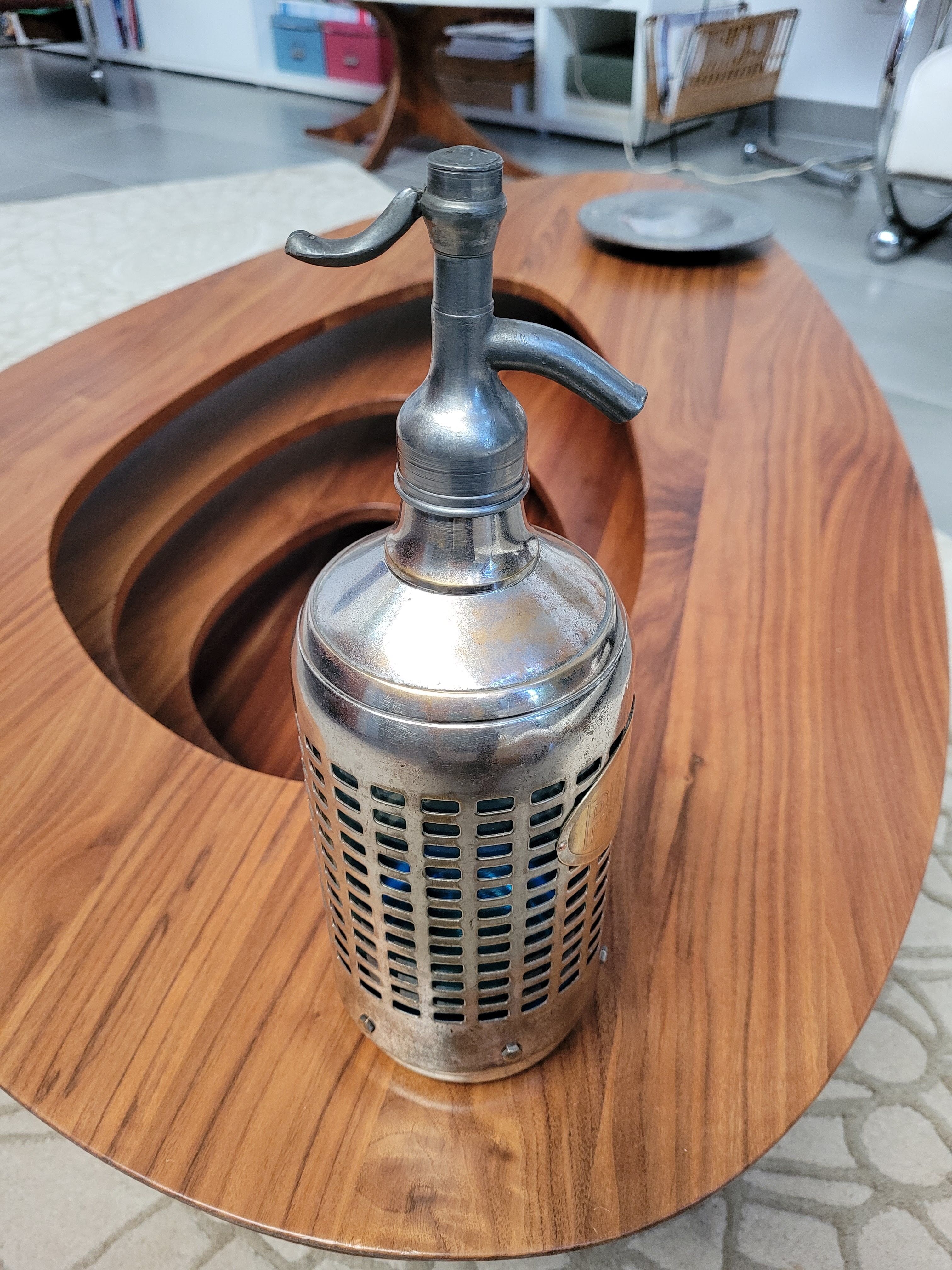 Seltzer water siphon in its protective grid