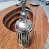 Seltzer water siphon in its protective grid