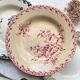 10 mismatched vintage soup plates in blue, green, and red ironstone