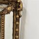 Louis XVI style mirror with parecloses in wood and gilded stucco, 19th century