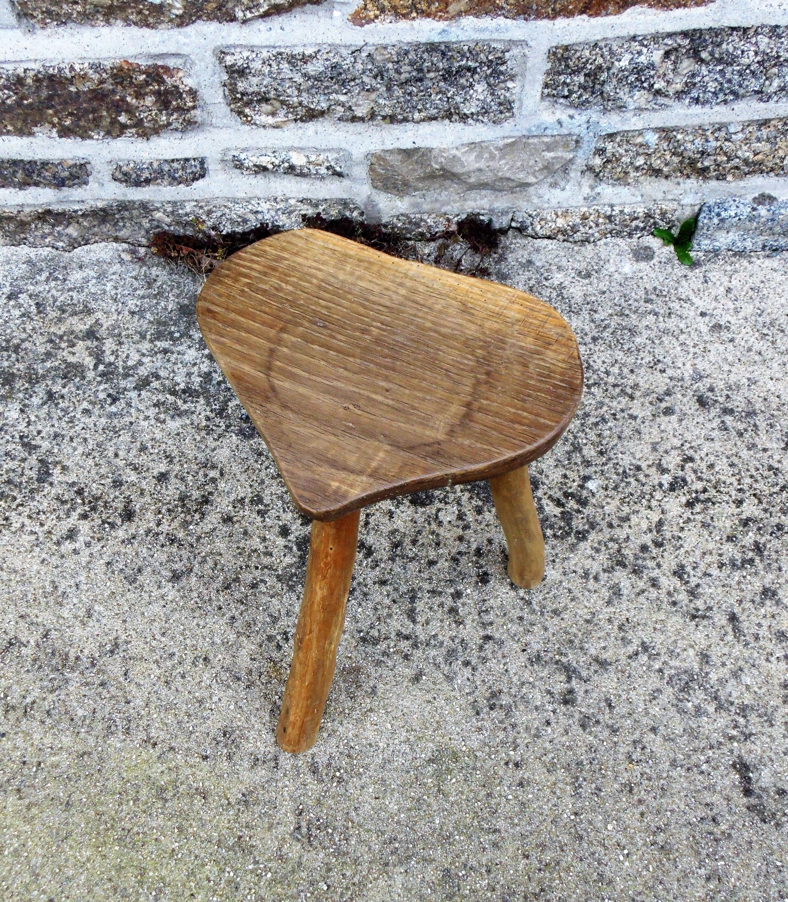Farm stool in raw wooden sitting in the shape of a popular art
