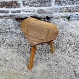 Farm stool in raw wooden sitting in the shape of a popular art