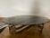 Table basse oval en métal chromé  et verre fumé forme  esse