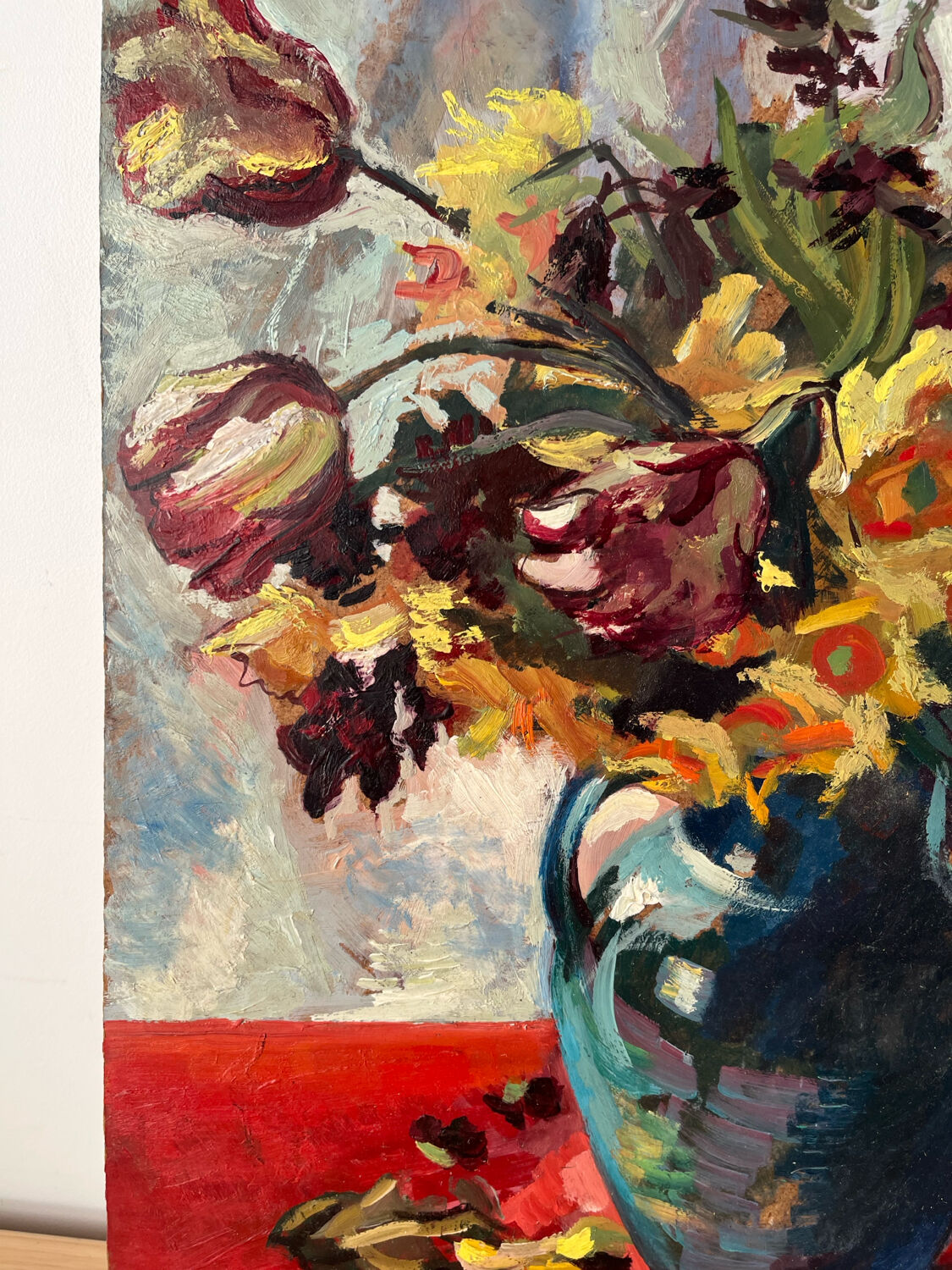 Bouquet of flowers on a red tablecloth, knife on a board, signed Renzo.