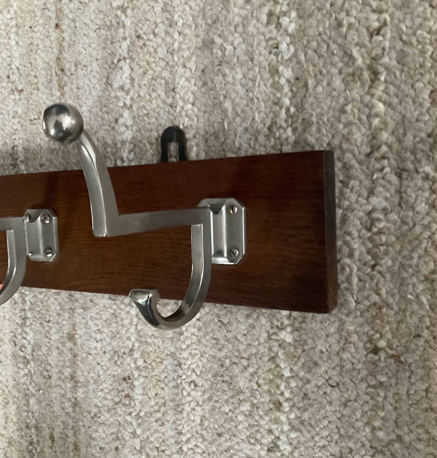 Wall coat rack from the 1950s-60s in solid oak and stainless steel.