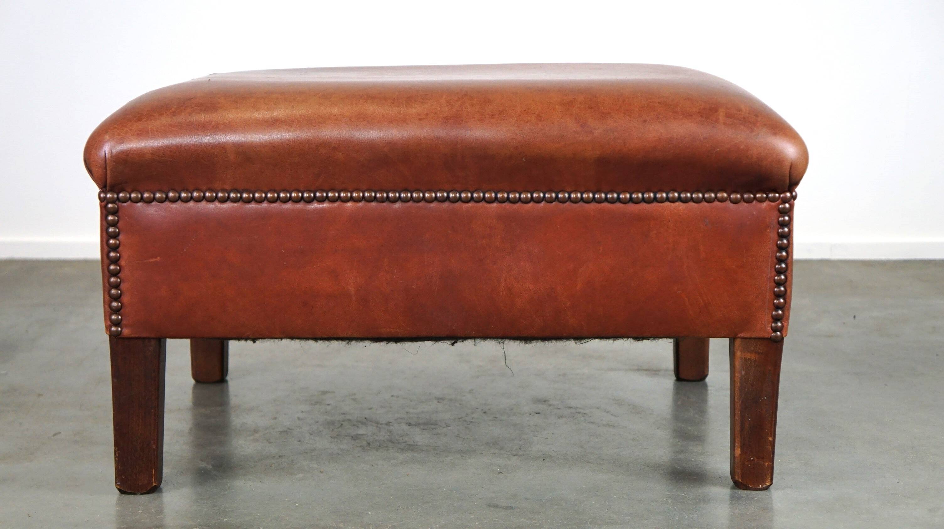 Leather ottoman in classic English style finished with decorative nails