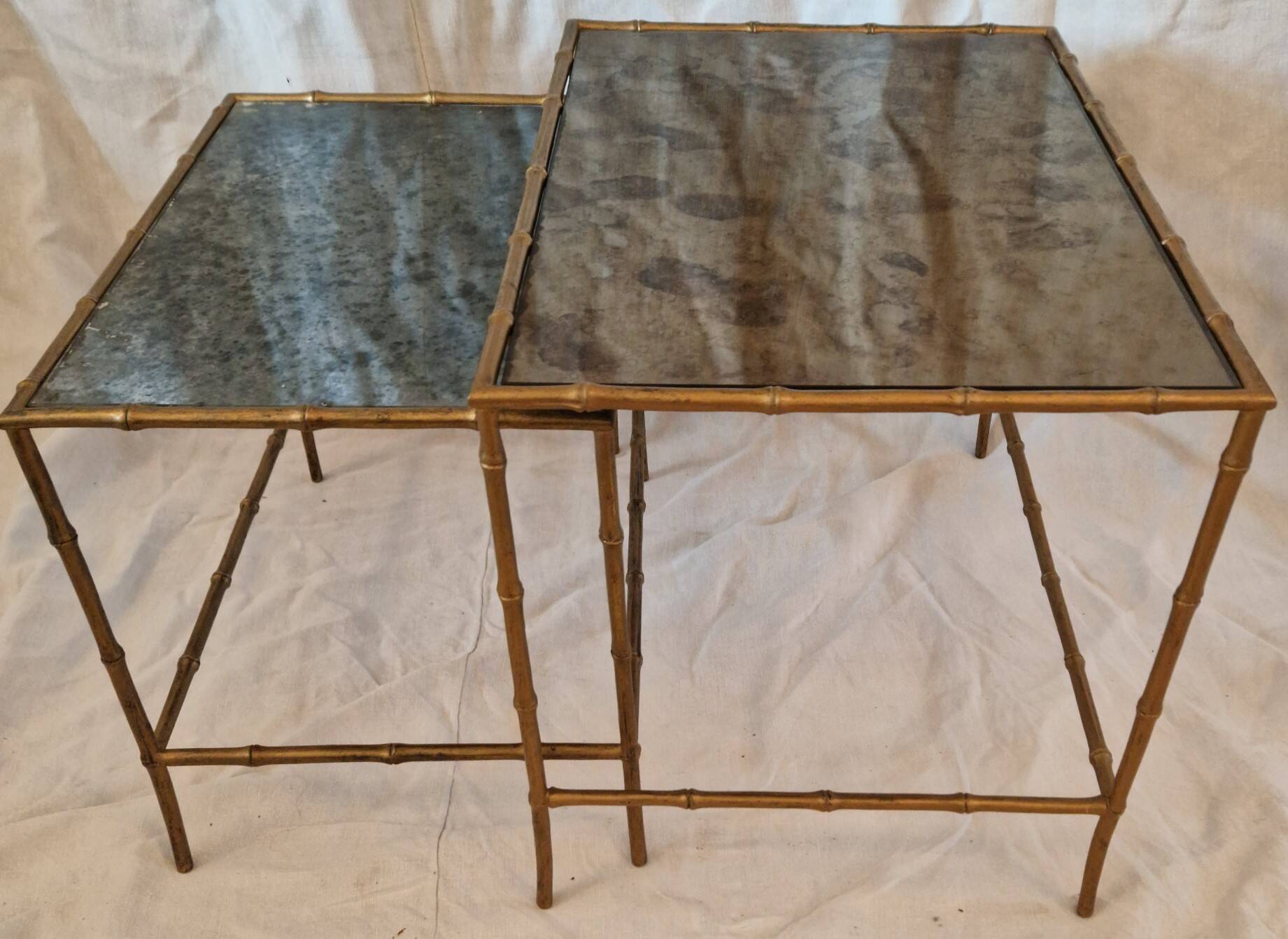 Pair of vintage nesting tables in faux bamboo with a gold finish – distressed mirrors