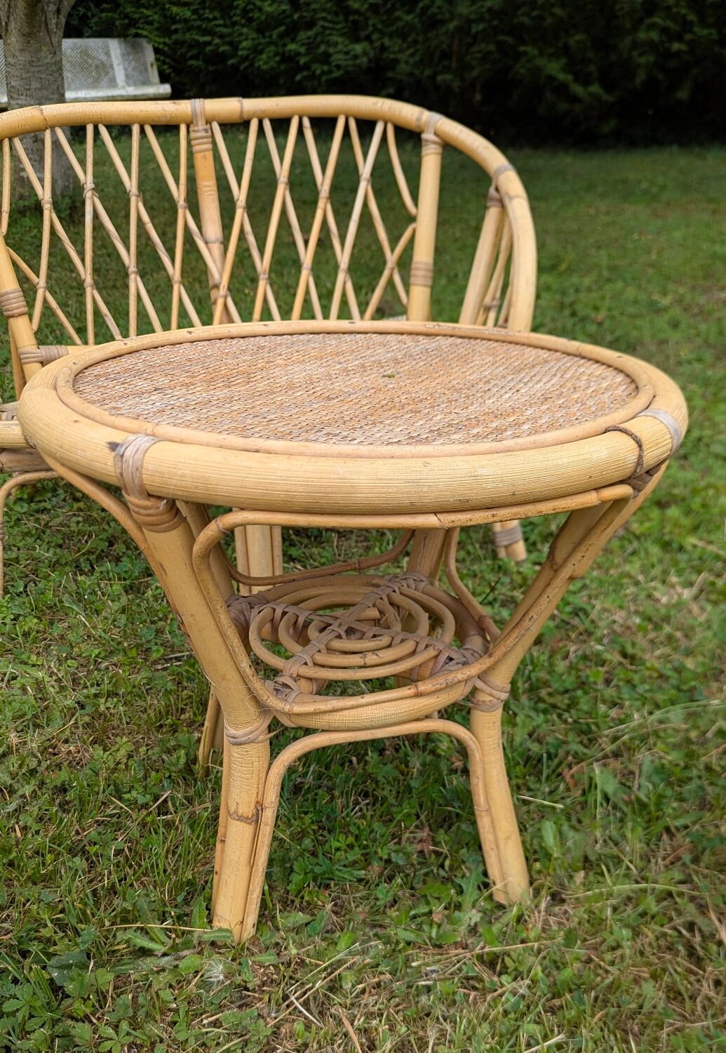 Set of children's rattan garden furniture from the 1950s and 1960s, including chairs, table, and bench.