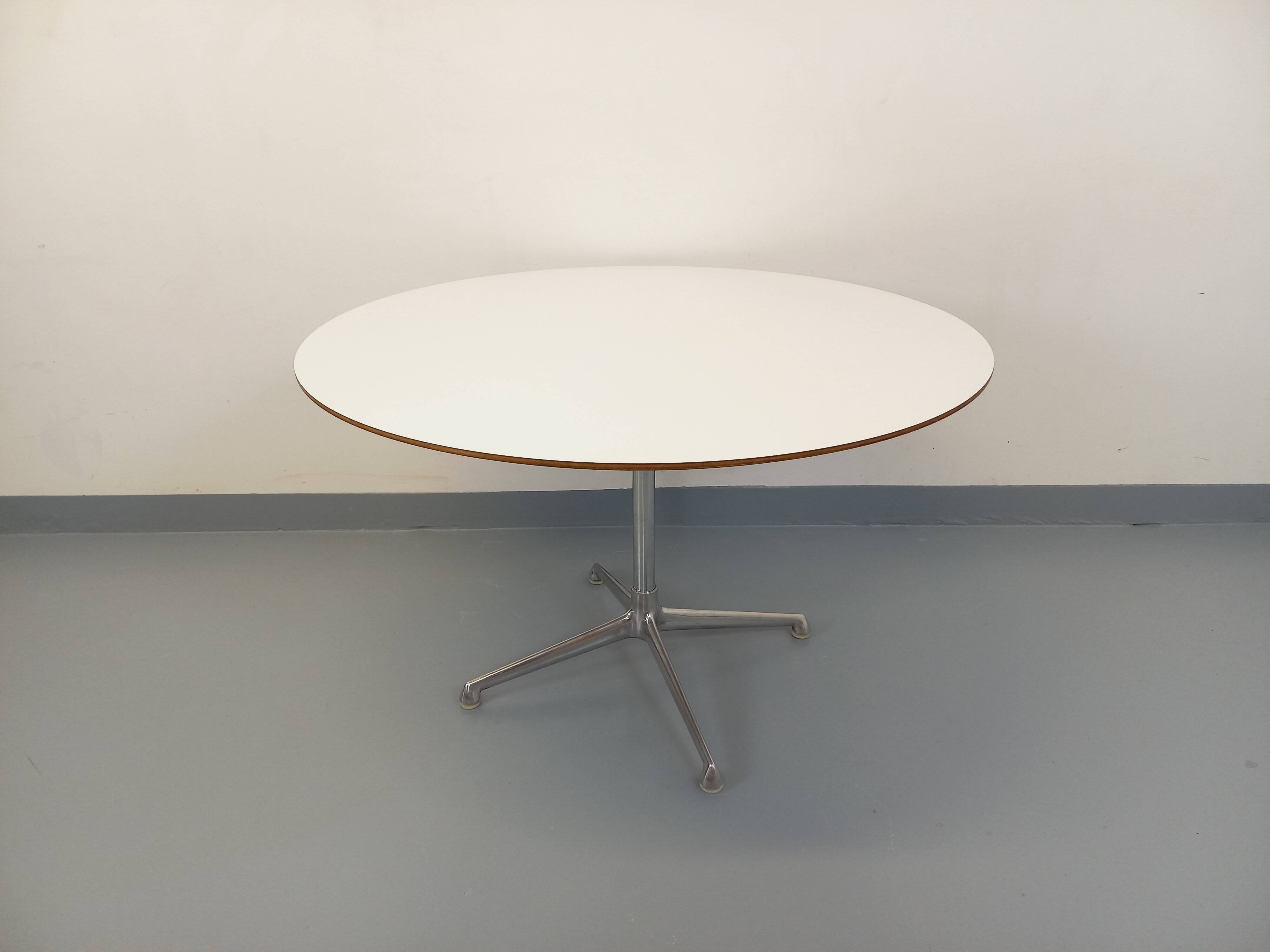 Vintage Eames round table for Vitra in white melamine, wood, and metal.